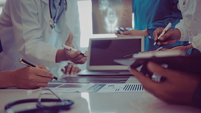 Medical professionals reviewing patient records and an X-ray